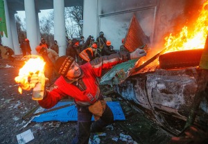 A protester throws a Molotov cocktail during an anti-government protest in downtown Kiev. Source